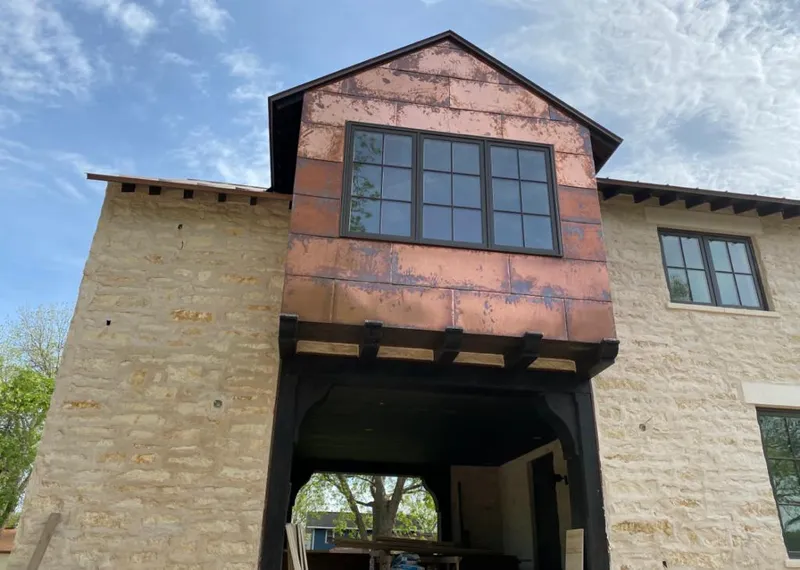 Copper metal panel facade on a stone building for Metal Roof Coating in Macomb