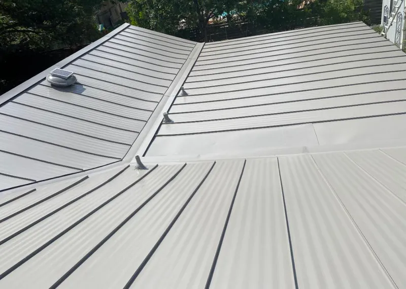 Solar attic fan installed on a metal roof for Roof Ventilation in Macomb